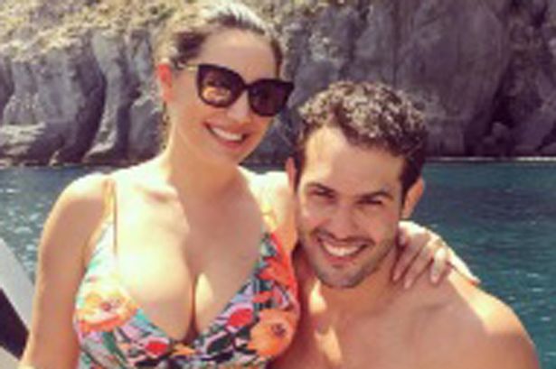 Kelly Brook puts on an eye-popping display as her swimsuit struggles to contain her cleavage