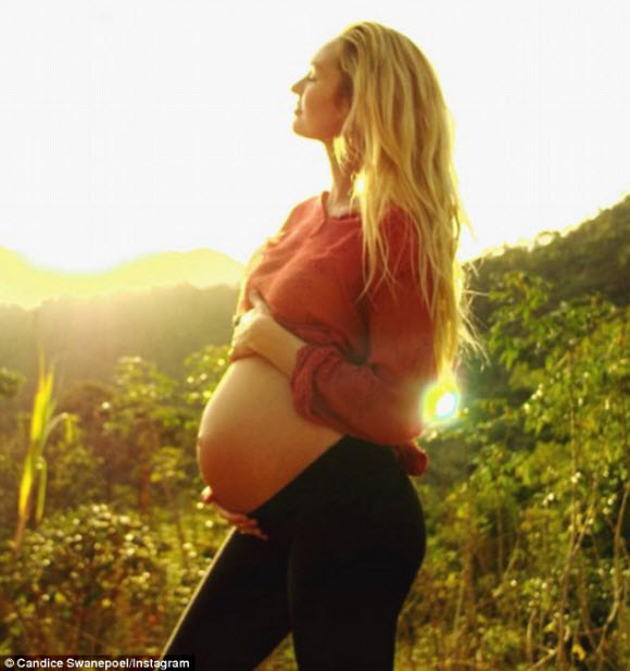 Candice Swanepoel shares her huge baby bump in quirky Instagram snap